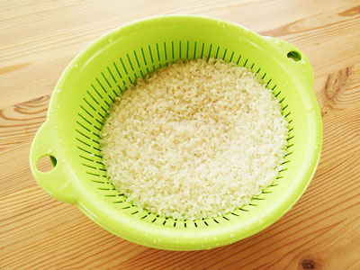 水で洗ってざるに上げた米