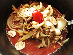 鍋に炒めた牛肉と玉ねぎ、マッシュルーム、牛乳、トマトジュース、ケチャップ、醤油、ウスターソース、コンソメを入れる。