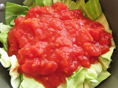 具を炒めている鍋にキャベツとトマト缶の中身を入れる。