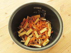 米と調味料、水の入った炊飯器の内釜にしめじとにんじん、生姜を入れる。。