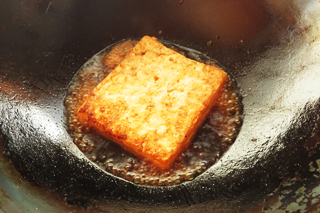 木綿豆腐を焼いているフライパンに、ソースをくわえる。